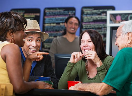Joyful group of adults sitting in a cafe